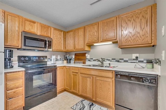 kitchen with a textured ceiling, sink, and black appliances