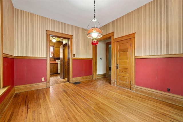 unfurnished dining area with hardwood / wood-style flooring and ceiling fan