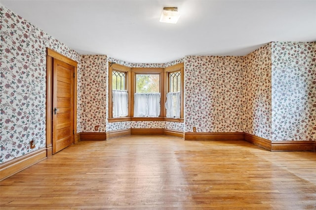 empty room with light hardwood / wood-style flooring