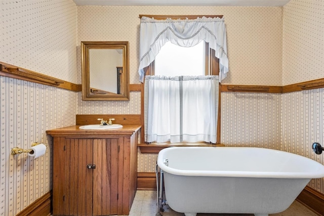 bathroom with vanity, a bath, and tile patterned floors