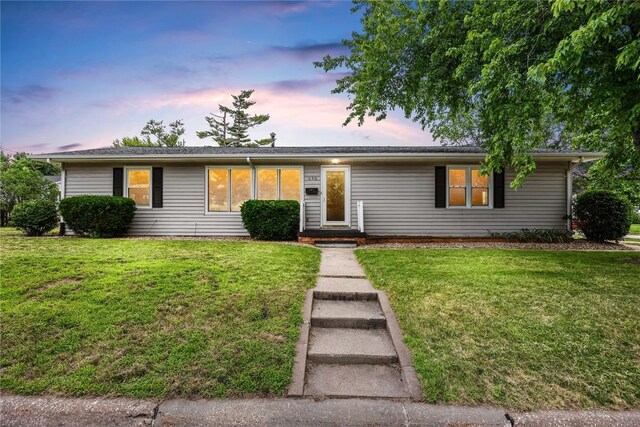 ranch-style house with a lawn