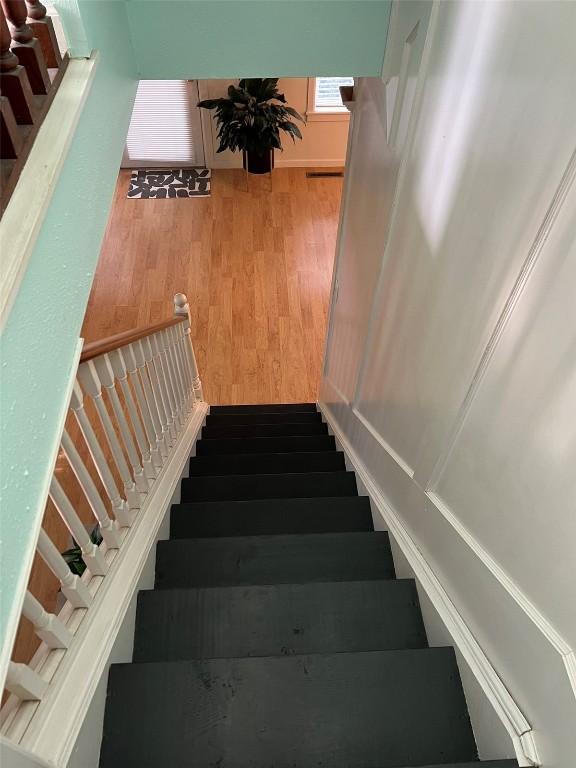 stairway featuring wood finished floors