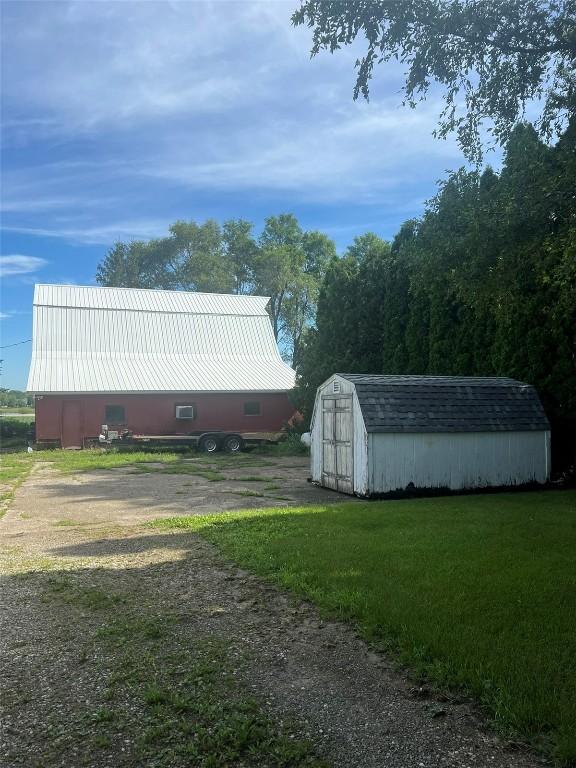 view of outbuilding with dirt driveway and an outdoor structure