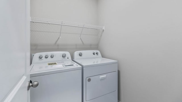 laundry room with washing machine and dryer