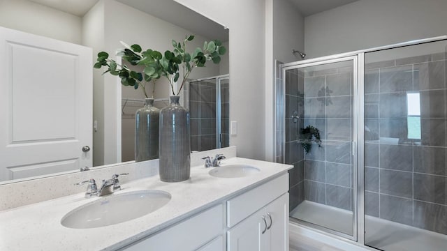 bathroom featuring vanity and a shower with shower door