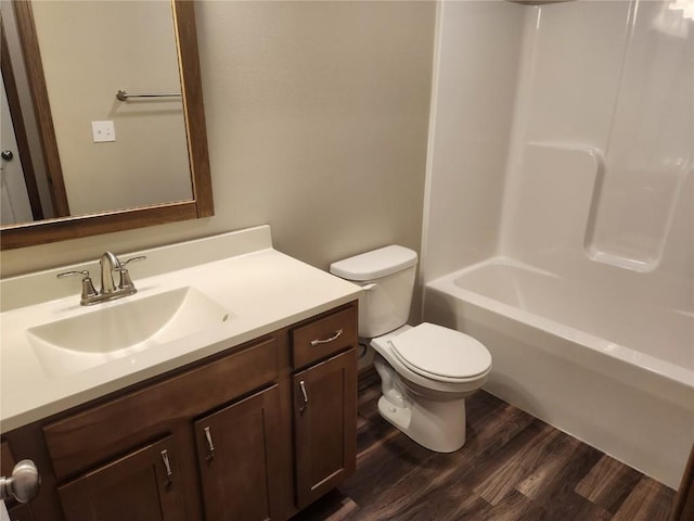 full bath featuring toilet, shower / bathing tub combination, wood finished floors, and vanity