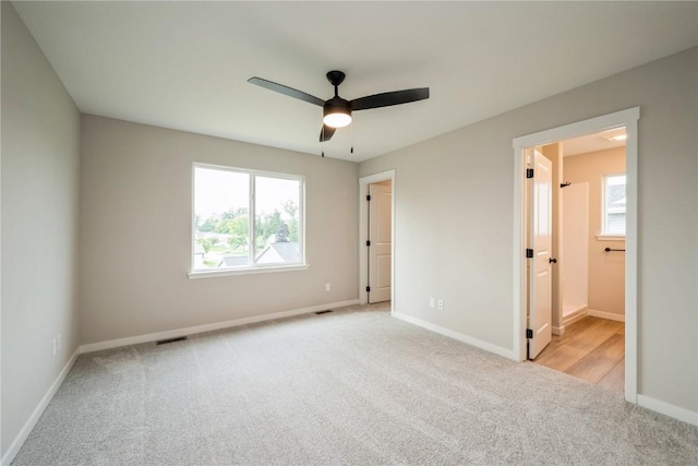 unfurnished bedroom with baseboards, visible vents, and carpet flooring