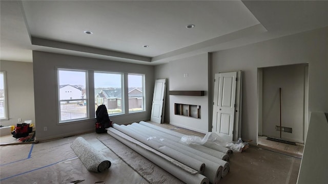 unfurnished bedroom featuring a fireplace and a tray ceiling