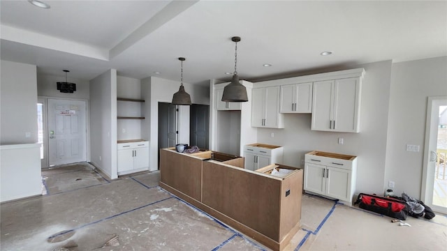 kitchen with pendant lighting, white cabinetry, and a kitchen island