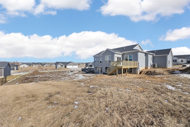 rear view of house featuring a wooden deck