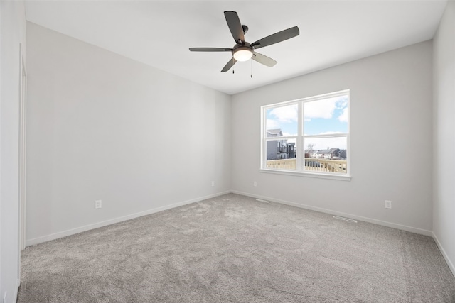 empty room with ceiling fan and carpet