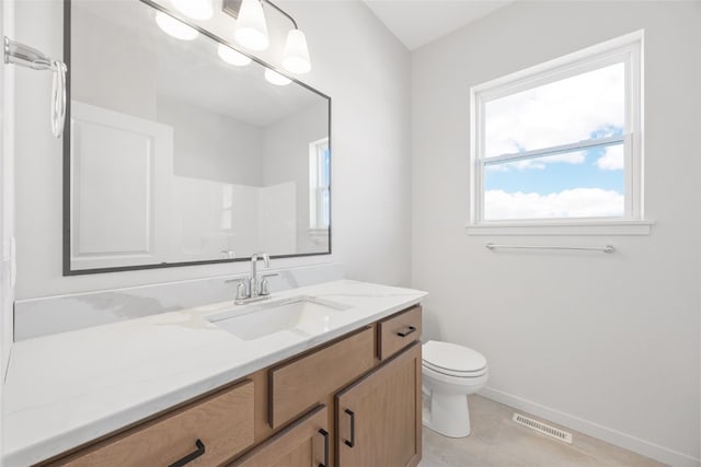 bathroom featuring walk in shower, vanity, and toilet