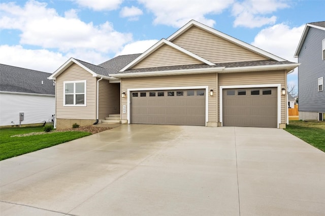 view of front of house featuring a front lawn and a garage