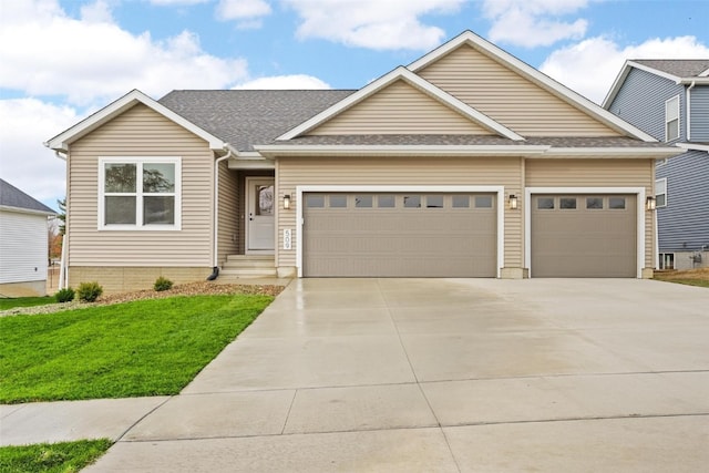 view of front of house with a front yard and a garage