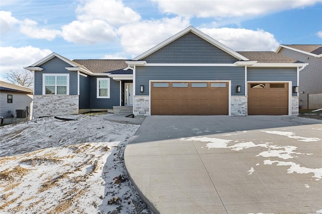 view of front of house featuring cooling unit and a garage