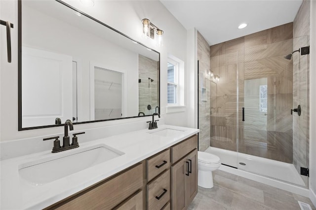 bathroom featuring toilet, vanity, and walk in shower