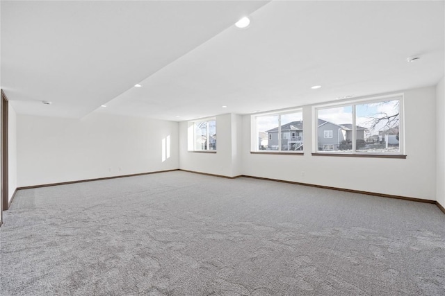 carpeted spare room featuring plenty of natural light