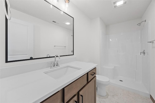 bathroom with tile patterned floors, a shower, vanity, and toilet