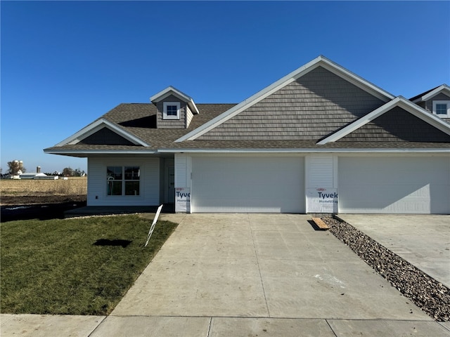 view of front of property with a garage and a front yard