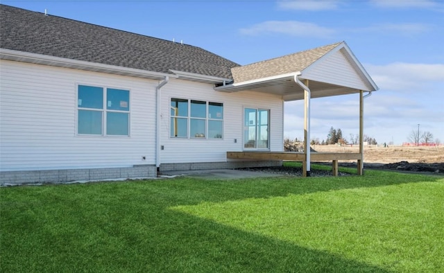 rear view of house with a yard