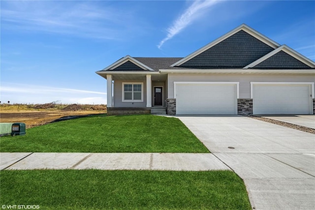 craftsman house with a front yard and a garage