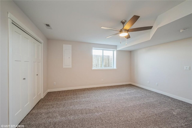 unfurnished bedroom featuring ceiling fan, electric panel, carpet floors, and a closet