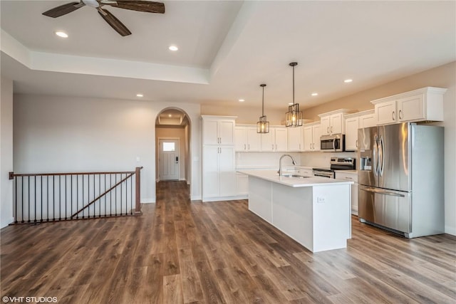 kitchen featuring sink, white cabinets, hanging light fixtures, a kitchen island with sink, and stainless steel appliances