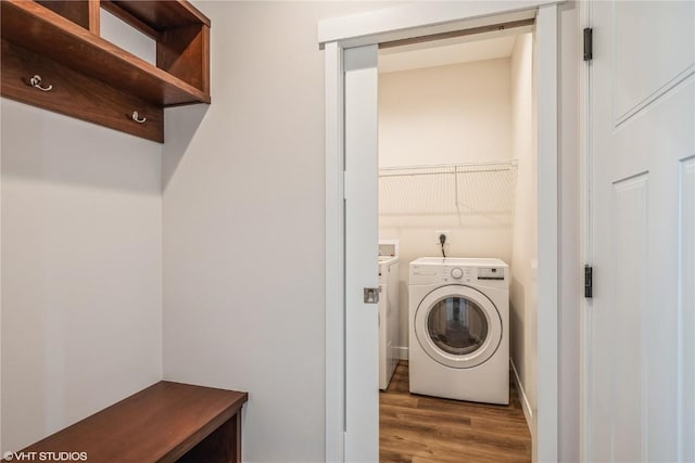 clothes washing area with washer / clothes dryer and hardwood / wood-style floors