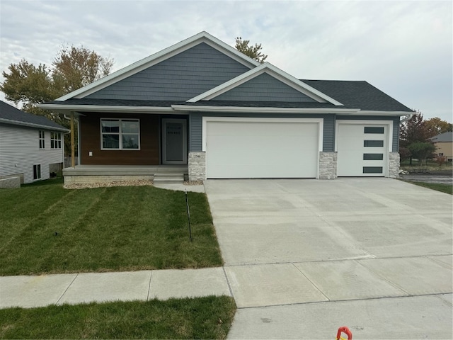 view of front of home with a garage and a front lawn