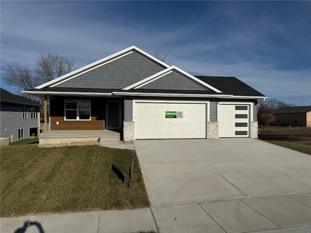 view of front of property with a garage and a front lawn