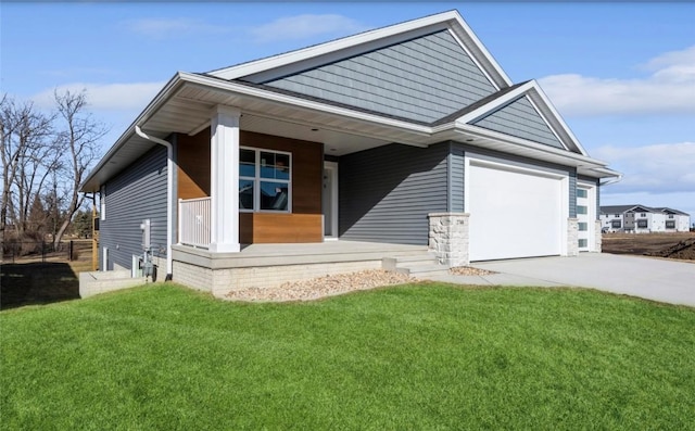 view of front facade with a garage, a front yard, and a porch