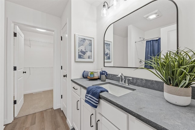 bathroom with vanity, wood-type flooring, and a shower with curtain