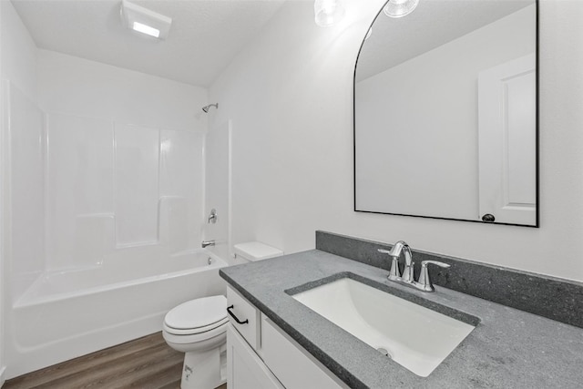 full bathroom featuring vanity, toilet, hardwood / wood-style floors, and shower / bathtub combination