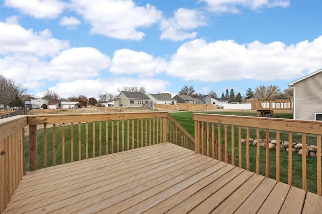 wooden deck featuring a yard