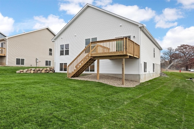 rear view of house featuring a deck and a lawn