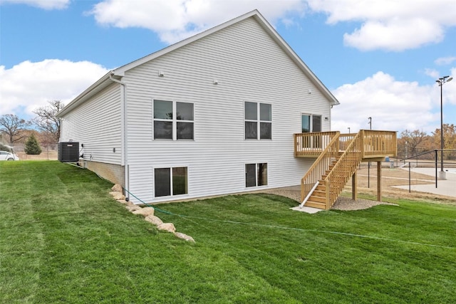 back of property featuring a wooden deck, central AC, and a lawn