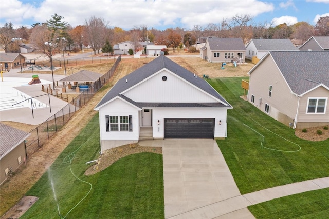 view of front of house with a front yard and a garage