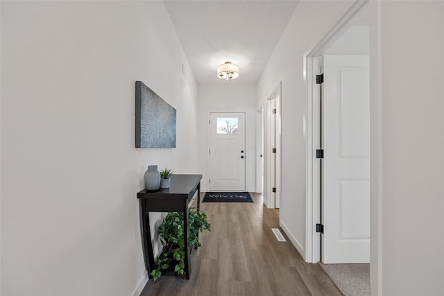 doorway to outside with wood-type flooring