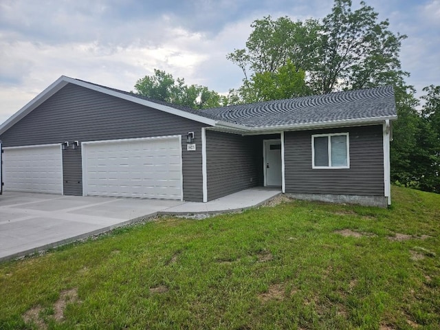 ranch-style home with a garage and a front lawn