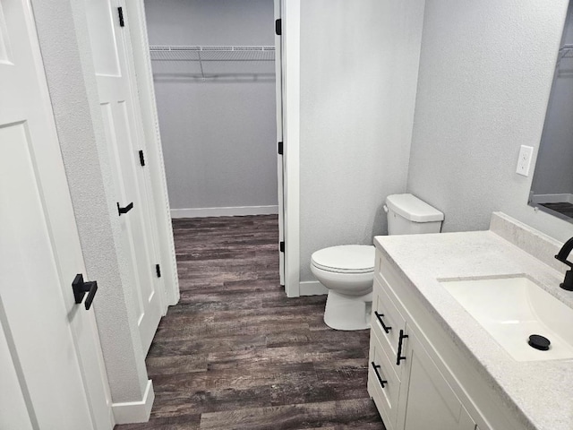 bathroom featuring hardwood / wood-style flooring, vanity, and toilet