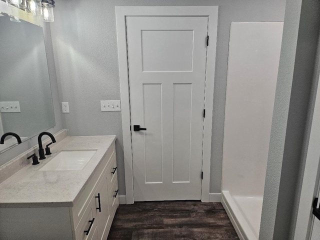 bathroom with hardwood / wood-style flooring and vanity