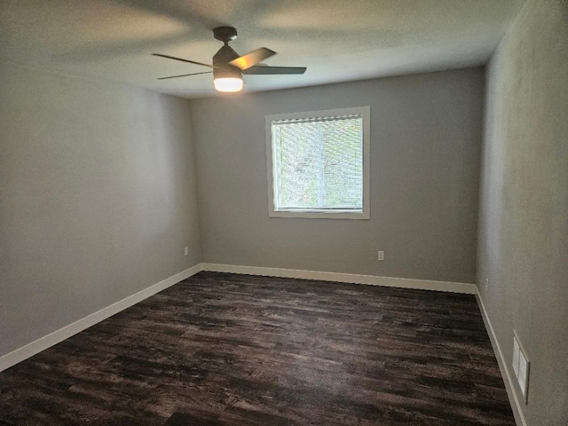 unfurnished room with dark wood-type flooring, a textured ceiling, and ceiling fan