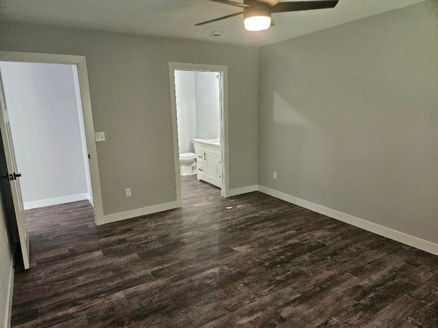 unfurnished bedroom featuring dark hardwood / wood-style flooring, ensuite bath, and ceiling fan