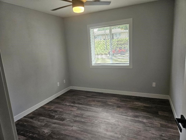 spare room featuring ceiling fan and dark hardwood / wood-style flooring