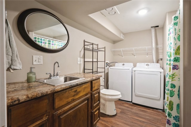 bathroom featuring vanity, washer and dryer, hardwood / wood-style flooring, and toilet