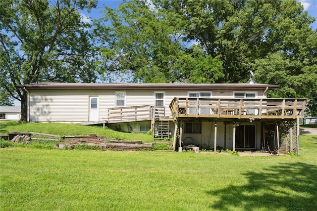 rear view of house with a deck and a lawn