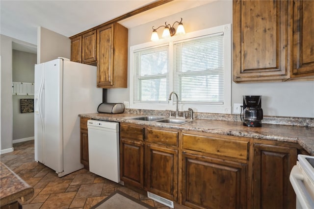 kitchen featuring sink and white appliances