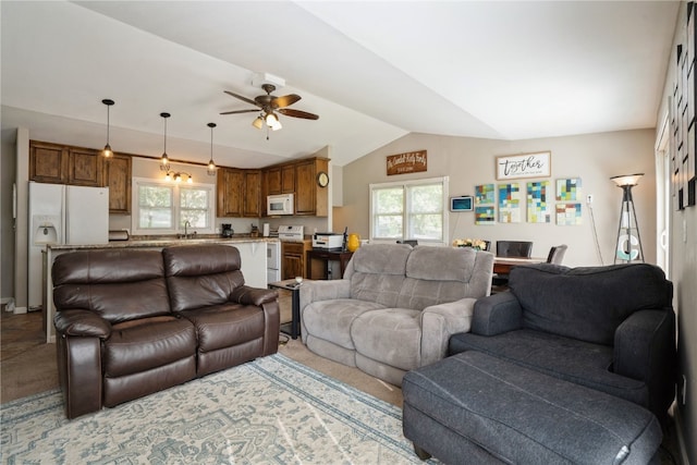 living room featuring lofted ceiling, sink, and ceiling fan