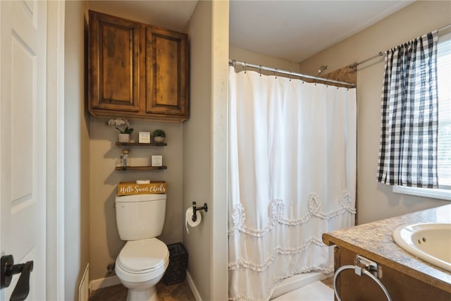 bathroom with a healthy amount of sunlight, vanity, a shower with curtain, and toilet