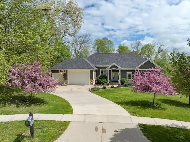 view of front of property with a garage and a front yard